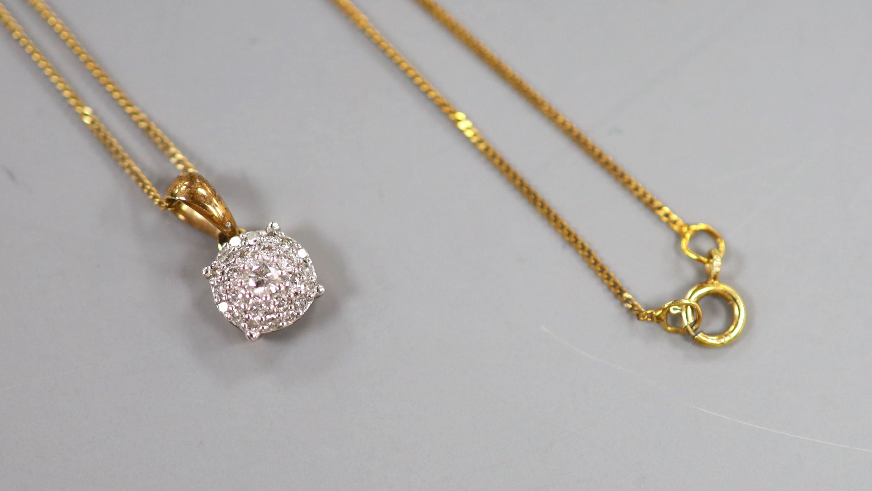 An illusion-set diamond pendant on 9ct gold fine chain and a matching pair of earrings